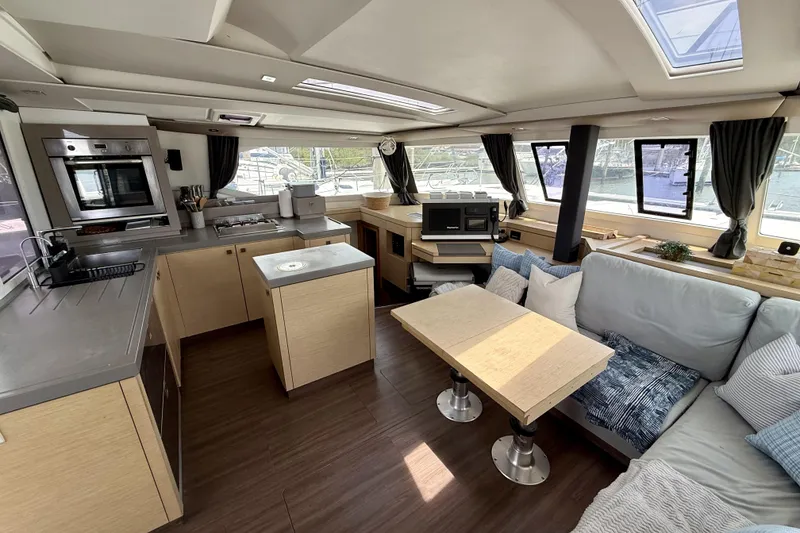 Slide: The Image of Luxurious interior of 2018 Fountaine Pajot Saona 47 catamaran with modern kitchen and seating area. - 32