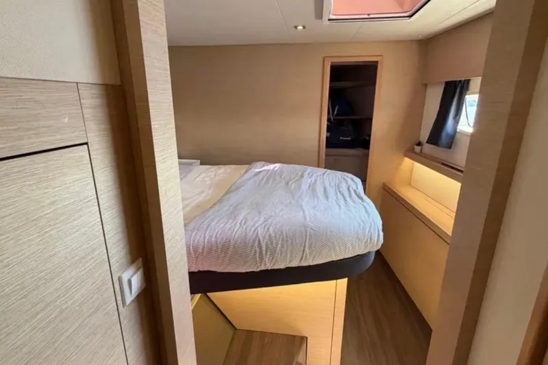 Slide: The Image of Interior cabin of 2018 Fountaine Pajot Saona 47 catamaran, featuring a cozy bed and modern design. - 36