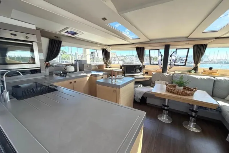 Slide: The Image of Luxurious interior of 2018 Fountaine Pajot Saona 47 catamaran with modern kitchen and seating area. - 4