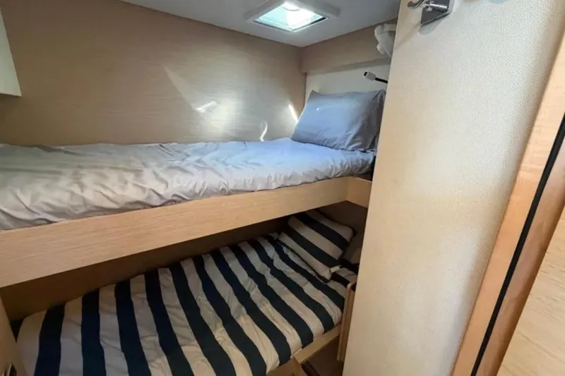 Slide: The Image of Bunk beds in 2018 Fountaine Pajot Saona 47 catamaran cabin, featuring cozy bedding. - 42