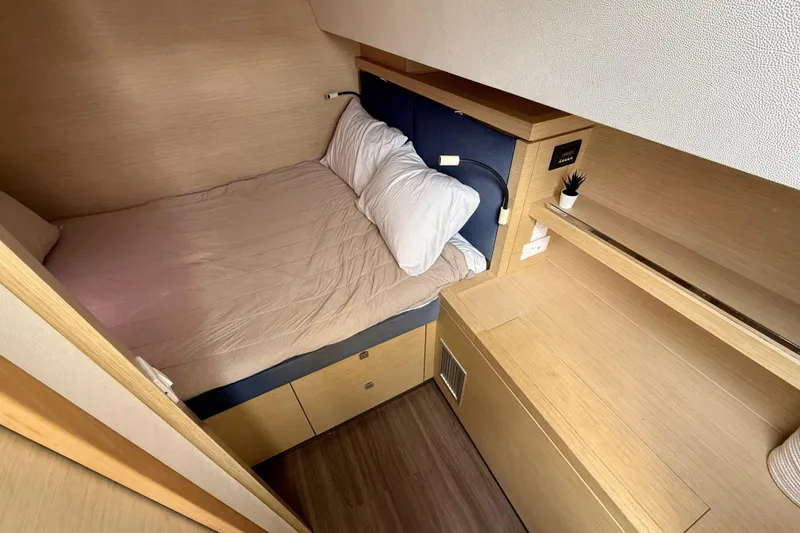 Slide: The Image of Cozy cabin interior of 2018 Fountaine Pajot Saona 47 yacht with bed and wooden furnishings. - 48