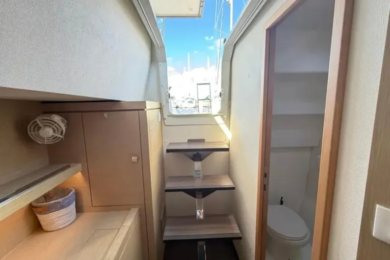 Slide: The Image of Interior of 2018 Fountaine Pajot Saona 47 yacht, featuring compact bathroom and storage shelves. - 49