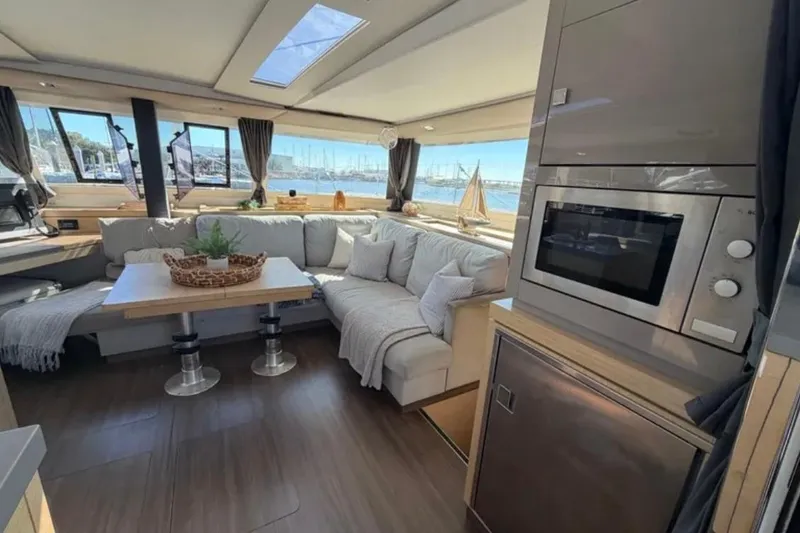Slide: The Image of Luxurious interior of 2018 Fountaine Pajot Saona 47 catamaran with modern kitchen and cozy seating area. - 5