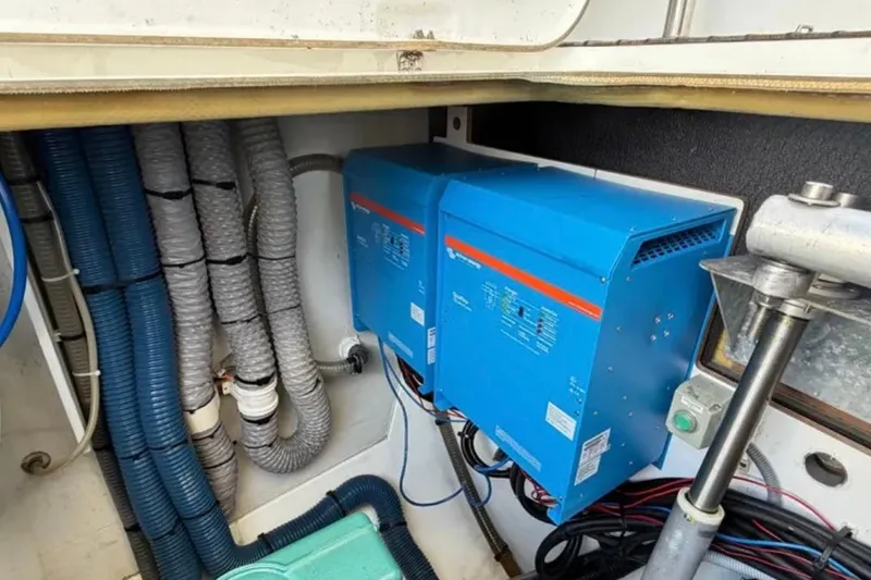 Slide: The Image of Electrical system inside 2018 Fountaine Pajot Saona 47 yacht, featuring blue inverters and wiring. - 53