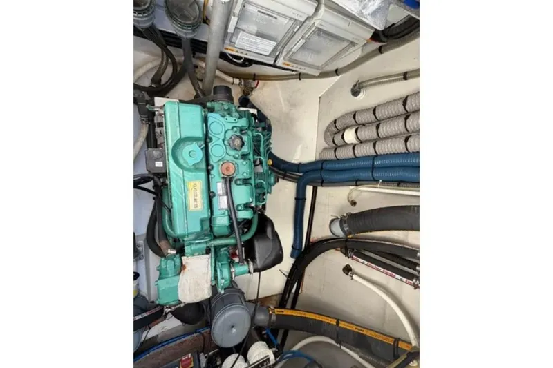 Slide: The Image of Engine room of 2018 Fountaine Pajot Saona 47 catamaran with visible machinery and hoses. - 56