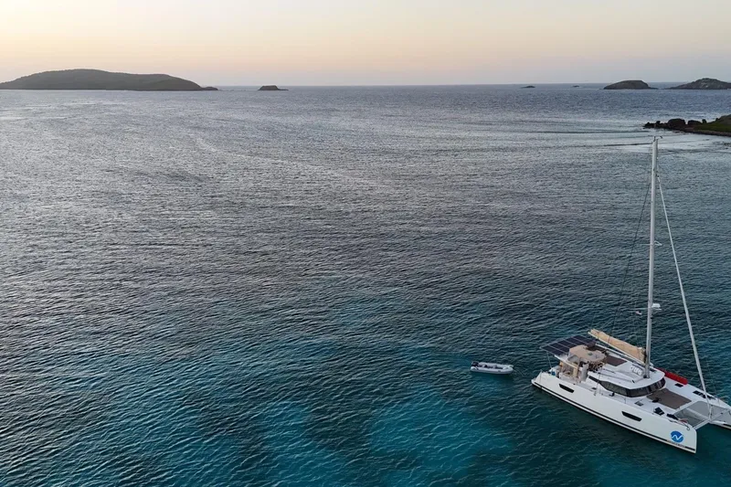 Slide: The Image of Aerial view of 2018 Fountaine Pajot Saona 47 catamaran anchored in serene ocean waters. - 58