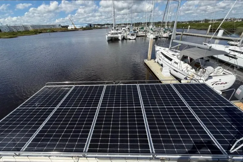 Slide: The Image of Solar panels on a 2018 Fountaine Pajot Saona 47 catamaran docked at a marina. - 60