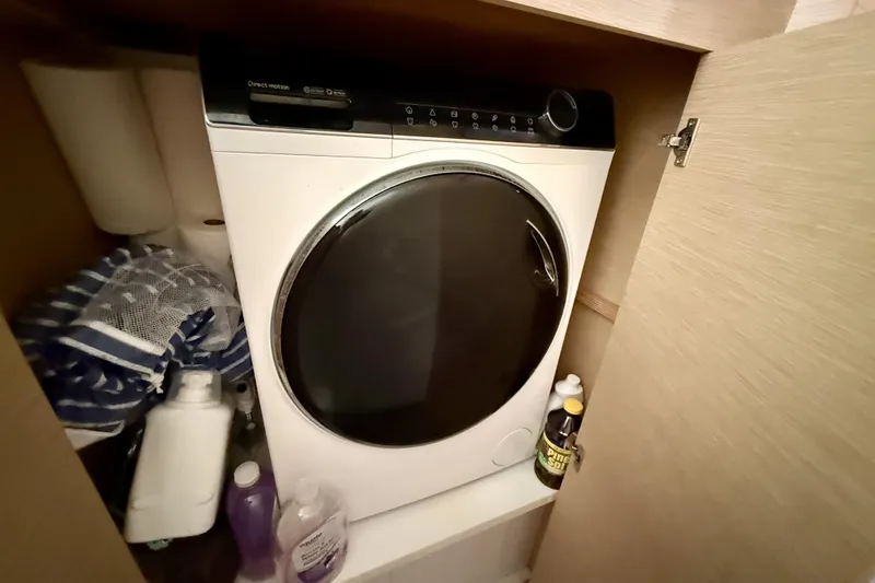 Slide: The Image of Laundry area on 2018 Fountaine Pajot Saona 47 yacht with washing machine and cleaning supplies. - 61