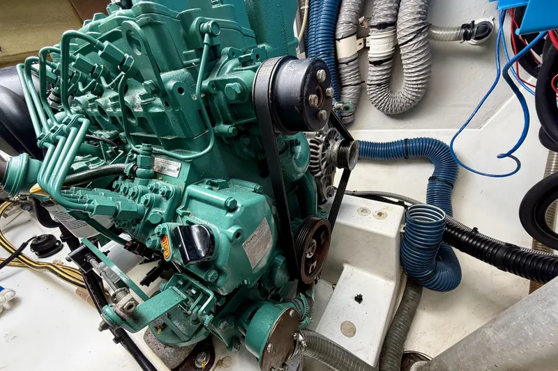 Slide: The Image of Engine compartment of a 2018 Fountaine Pajot Saona 47 catamaran, showcasing mechanical components and hoses. - 64