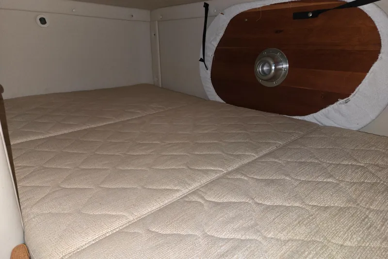 Slide: The Image of Interior cabin of a 2007 Monterey 270 Cruiser with beige quilted bedding. - 10