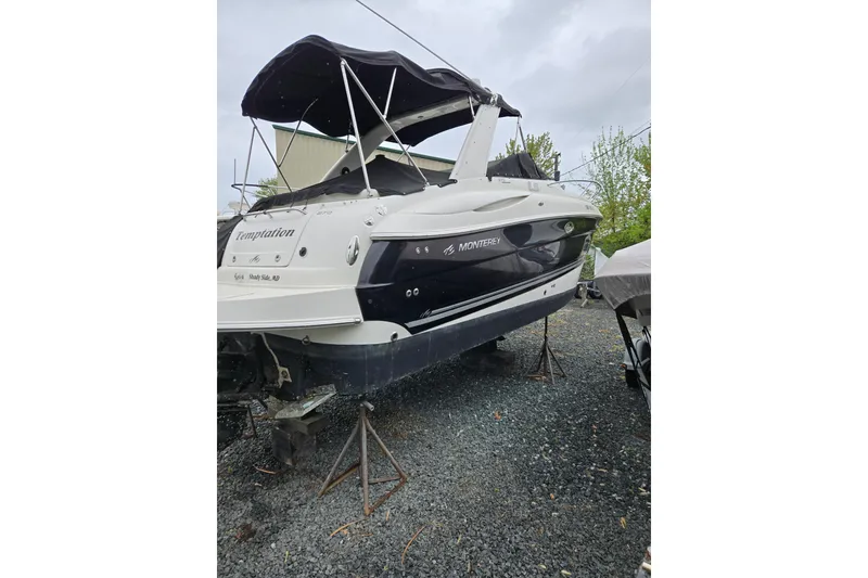 Slide: The Image of 2007 Monterey 270 Cruiser boat on stands, outdoor storage setting. - 11