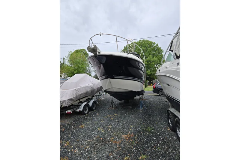 Slide: The Image of 2007 Monterey 270 Cruiser boat on stands in a gravel lot. - 3