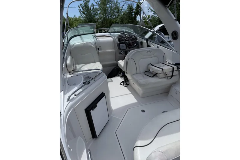 Slide: The Image of 2007 Monterey 270 Cruiser interior with white seating and modern dashboard. - 5