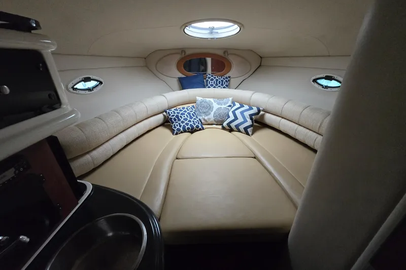 Slide: The Image of Interior cabin of 2007 Monterey 270 Cruiser with cozy seating and decorative pillows. - 7