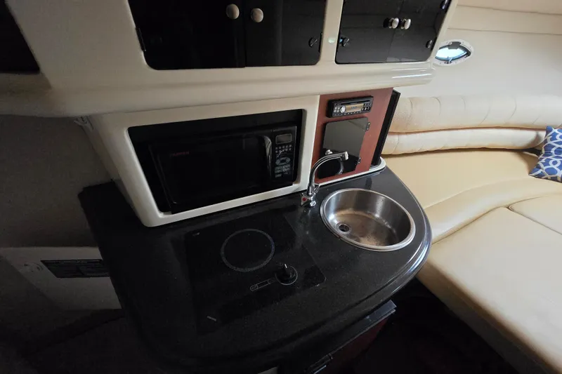 Slide: The Image of Compact kitchenette in a 2007 Monterey 270 Cruiser with sink, microwave, and stove. - 8