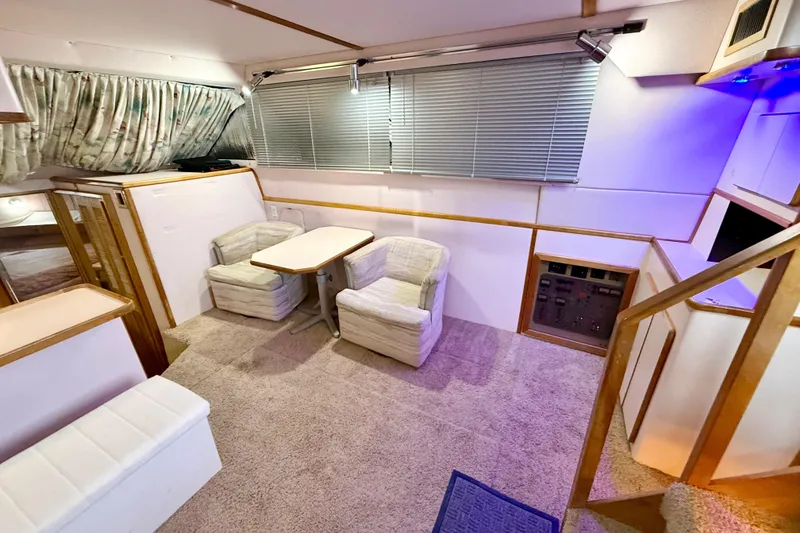Slide: The Image of 1989 Sea Ray 380 Aft Cabin interior with cozy seating and dining area. - 10