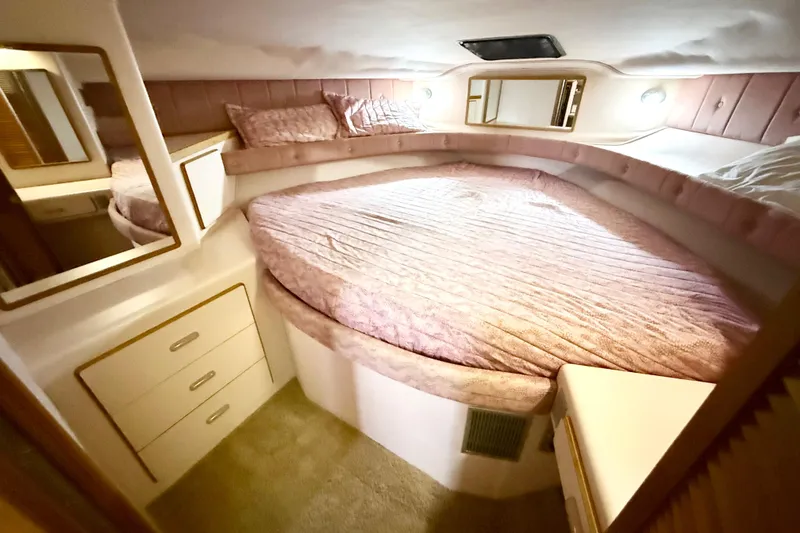 Slide: The Image of Cozy bedroom in 1989 Sea Ray 380 Aft Cabin yacht with pink bedding and storage. - 14