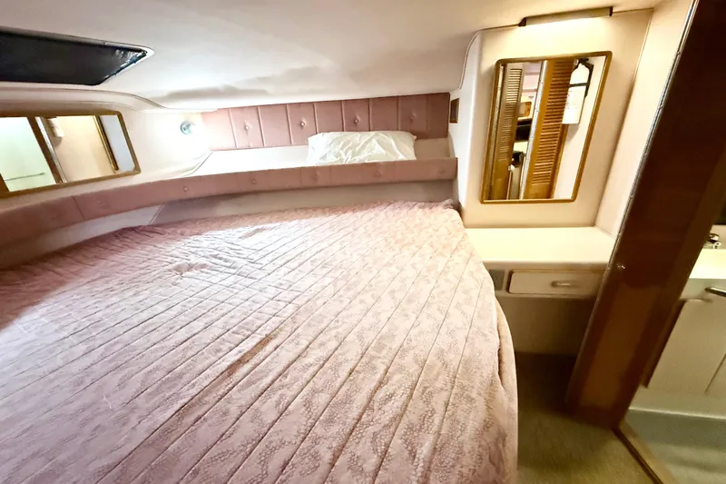 Slide: The Image of Cozy bedroom in 1989 Sea Ray 380 Aft Cabin yacht with pink bedding and mirror. - 15