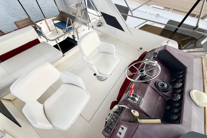 Slide: The Image of 1989 Sea Ray 380 Aft Cabin helm with white seating and control panel. - 2
