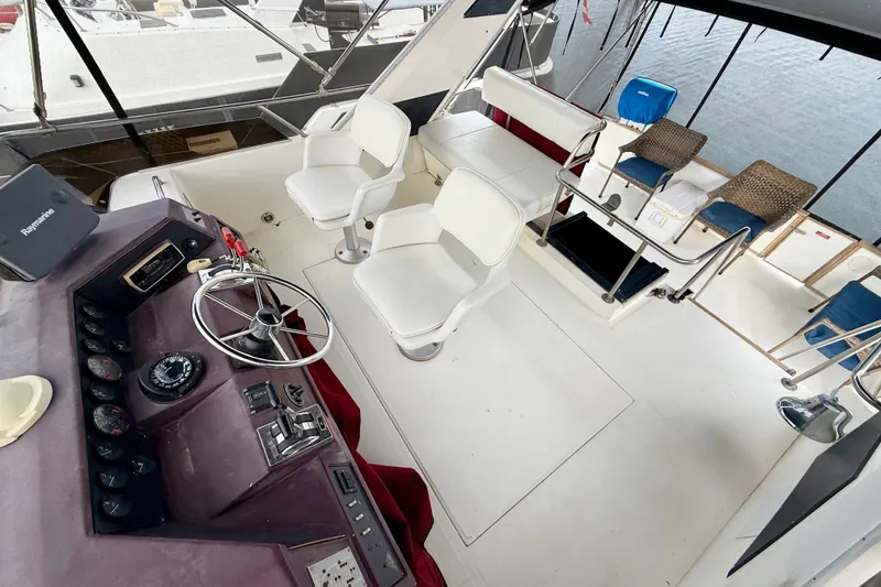 Slide: The Image of 1989 Sea Ray 380 Aft Cabin boat interior with helm, seating, and controls. - 3