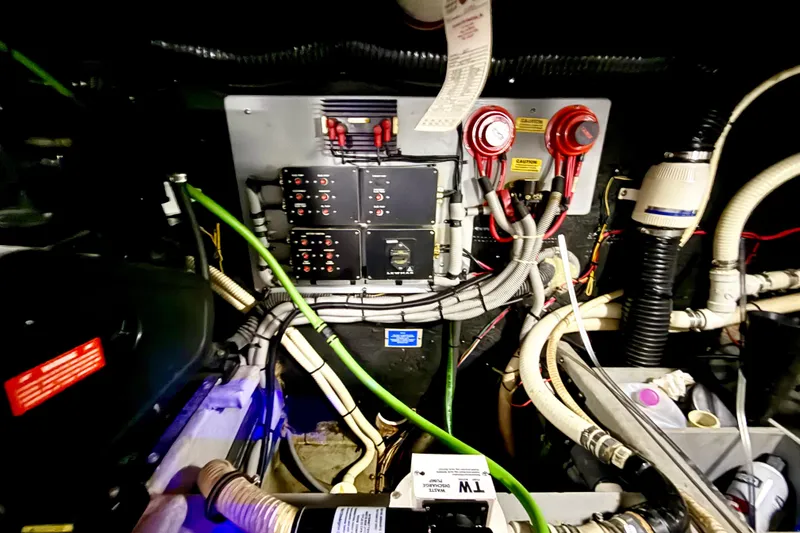 Slide: The Image of Engine room of 1989 Sea Ray 380 Aft Cabin with wiring and control panels. - 30