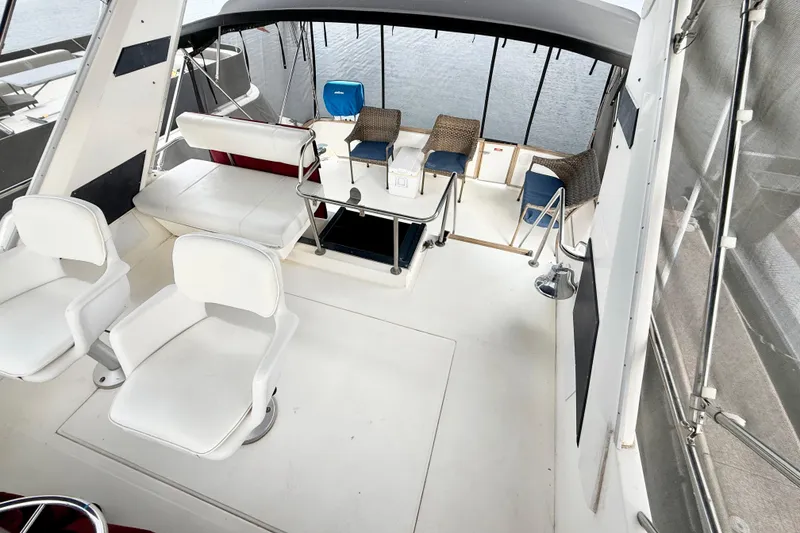 Slide: The Image of 1989 Sea Ray 380 Aft Cabin interior with white seating and spacious deck area. - 5