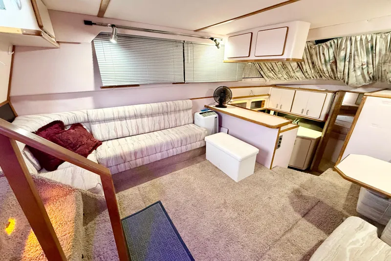 Slide: The Image of Interior of 1989 Sea Ray 380 Aft Cabin yacht with cozy seating and kitchenette. - 9
