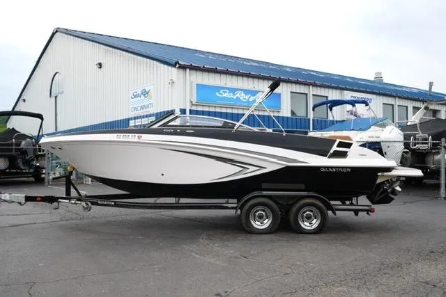 The Image of 2017 Glastron GT 245 boat on trailer outside dealership. - 1