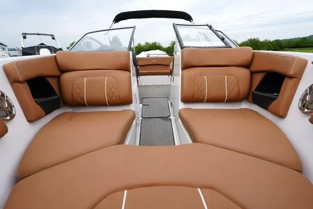 Slide: The Image of 2017 Glastron GT 245 boat interior with tan leather seating and open deck layout. - 10