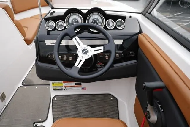 Slide: The Image of 2017 Glastron GT 245 boat dashboard with steering wheel and gauges. - 13