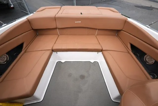 Slide: The Image of 2017 Glastron GT 245 boat interior with tan leather seating and spacious layout. - 16
