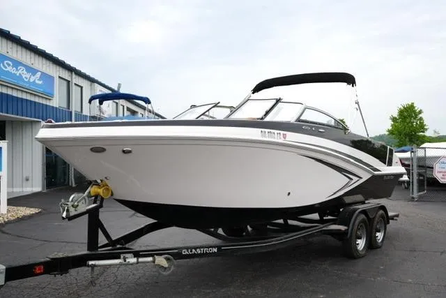 Slide: The Image of 2017 Glastron GT 245 boat on trailer outside dealership. - 2