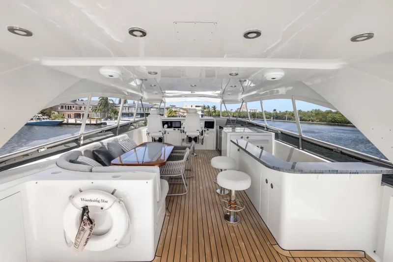 Slide: The Image of Luxurious 2009 Cheoy Lee 78 yacht deck with seating, bar, and scenic waterway view. - 15