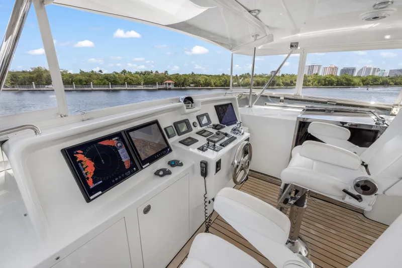 Slide: The Image of Helm of 2009 Cheoy Lee 78 yacht with navigation screens and white seating. - 17