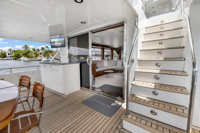 Slide: The Image of Luxurious 2009 Cheoy Lee 78 yacht interior with elegant seating, wooden deck, and staircase. - 21