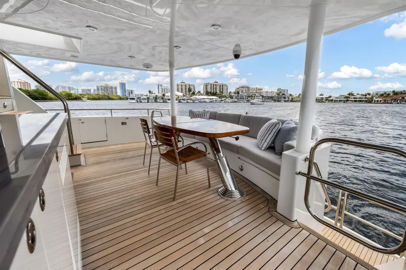 Slide: The Image of Luxurious 2009 Cheoy Lee 78 yacht deck with elegant seating and scenic waterfront view. - 24