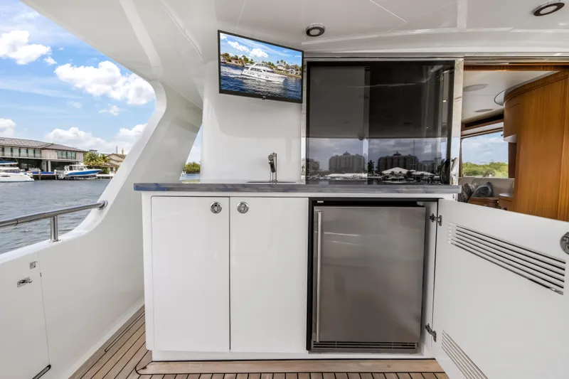 Slide: The Image of Luxurious Cheoy Lee 78 yacht interior with kitchenette and scenic water view, 2009 model. - 25