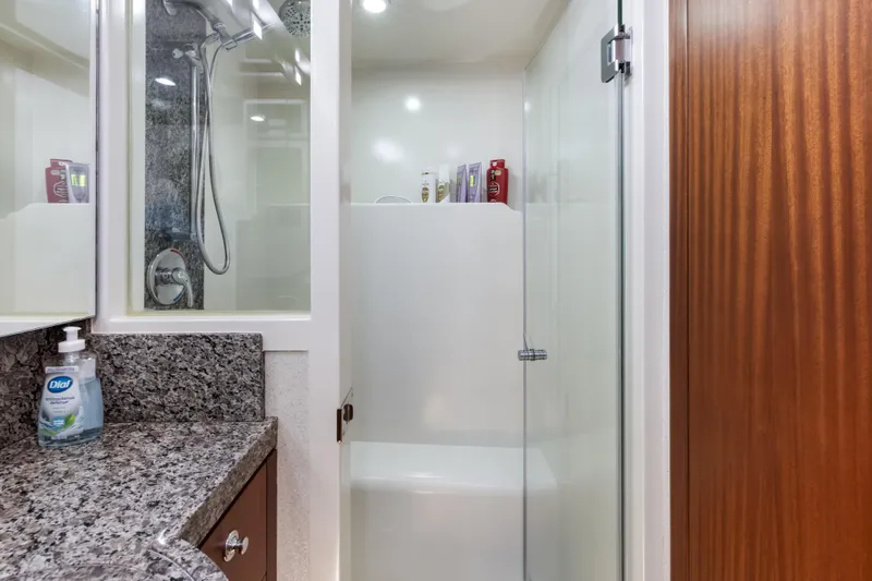 Slide: The Image of Luxurious Cheoy Lee 78 yacht bedroom, 2009 model, featuring elegant wood paneling and plush bedding. - 34