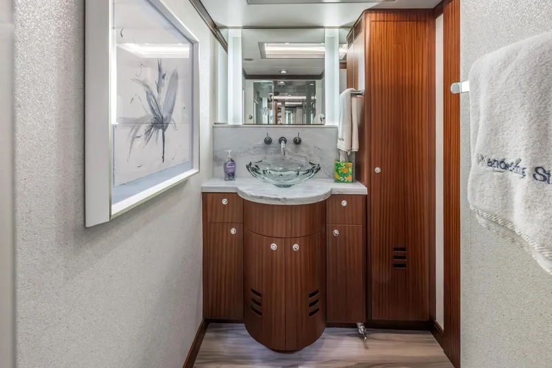 Slide: The Image of Luxurious Cheoy Lee 78 yacht bedroom interior, 2009 model, featuring elegant wood finishes and plush bedding. - 39