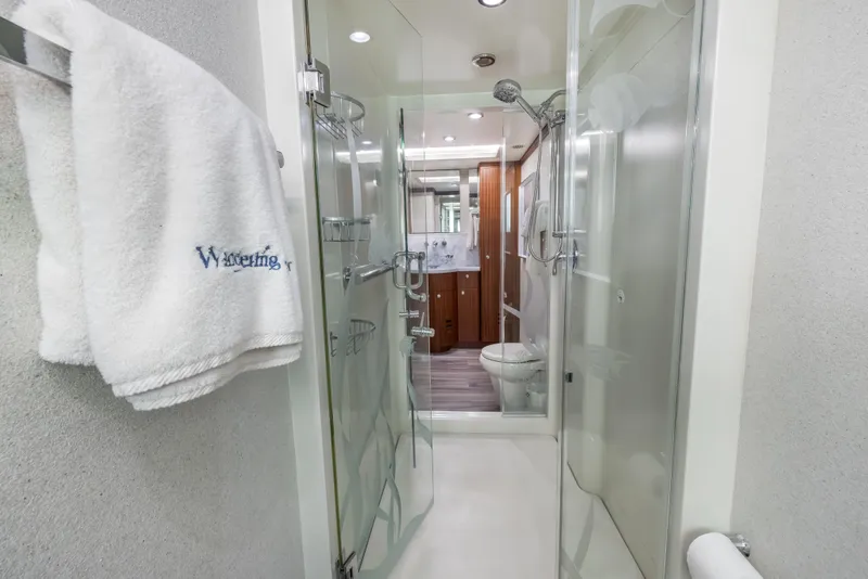 Slide: The Image of Luxurious 2009 Cheoy Lee 78 yacht bedroom with elegant wood paneling and modern decor. - 40