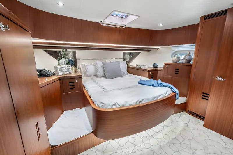 Slide: The Image of Luxurious Cheoy Lee 78 yacht bedroom interior, featuring elegant wood paneling and plush bedding, 2009 model. - 43