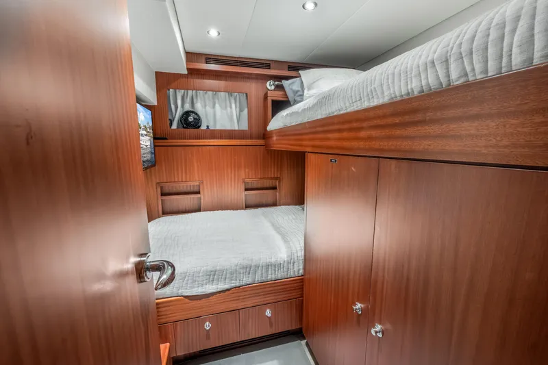 Slide: The Image of Luxurious Cheoy Lee 78 yacht bedroom interior, 2009 model, featuring elegant wood finishes and cozy bedding. - 45