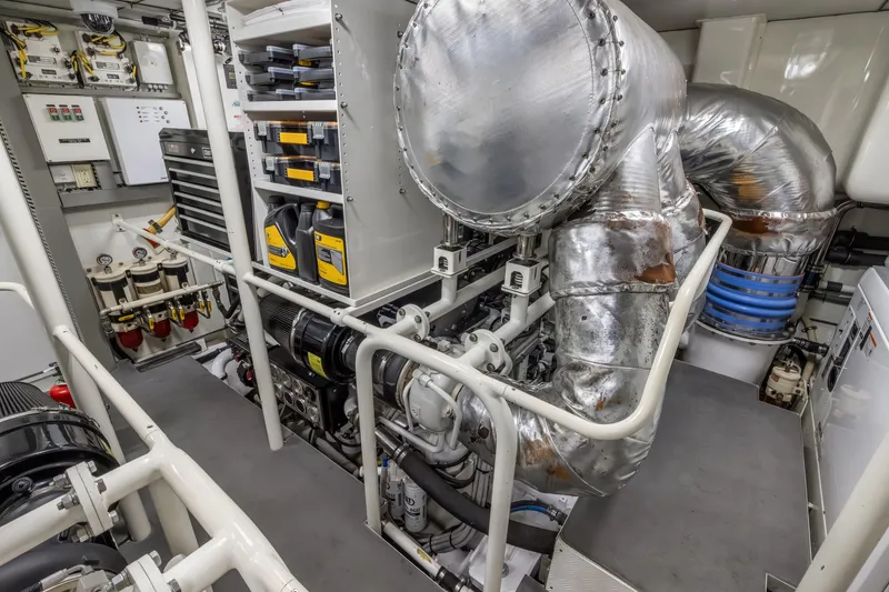 Slide: The Image of Engine room of 2009 Cheoy Lee 78 yacht, featuring complex machinery and piping. - 49