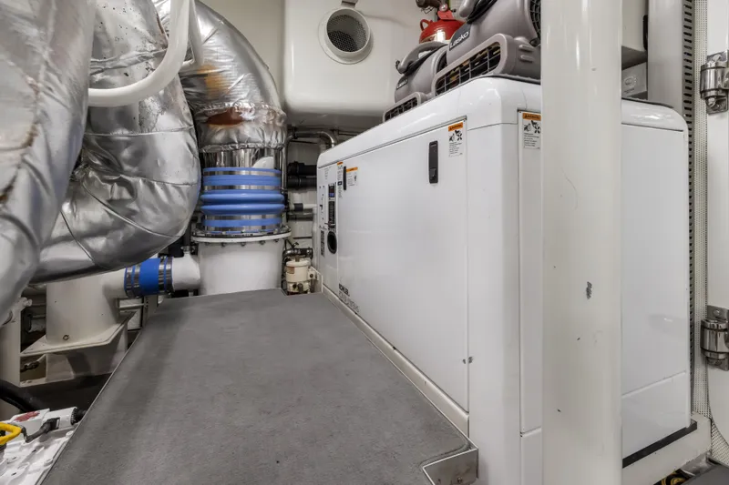 Slide: The Image of Engine room of a 2009 Cheoy Lee 78 yacht, featuring CAT machinery and advanced systems. - 52