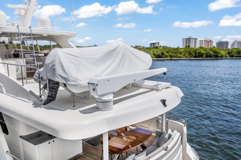 Slide: The Image of Luxury Cheoy Lee 78 yacht, 2009 model, docked by scenic waterfront with city skyline. - 7