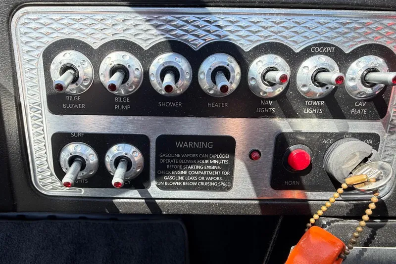 Slide: The Image of Control panel of a 2015 TomCat MB Sports Wake 22 boat with various switches. - 13