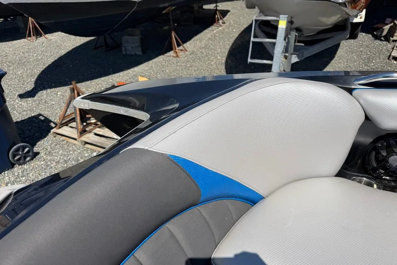 Slide: The Image of Interior of a 2015 TomCat MB Sports Wake 22 boat with gray and blue seating. - 18