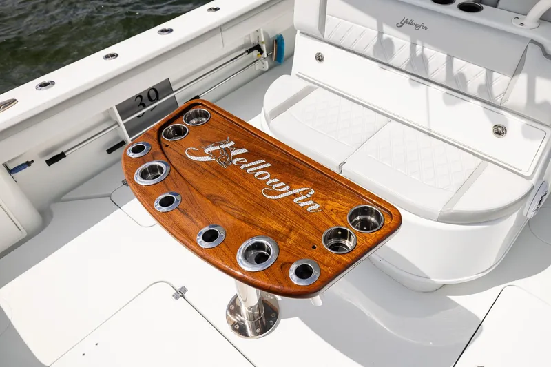 Slide: The Image of 2023 Yellowfin 39 Offshore boat with custom wooden table and seating area. - 44