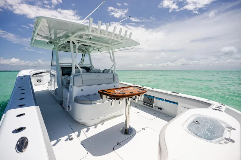 Slide: The Image of 2023 Yellowfin 39 Offshore boat on turquoise water under a clear sky. - 29