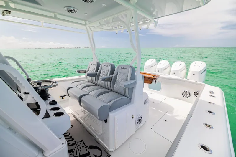 Slide: The Image of 2023 Yellowfin 39 Offshore boat interior with luxurious seating and multiple outboard engines. - 21